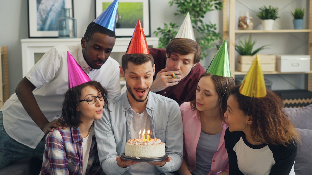 Friends gathered around the birthday cake during the celebration